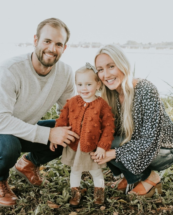 Mesa dentist Doctor Clark Julian smiling with his wife and young child