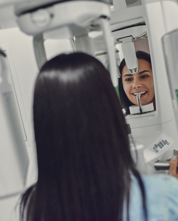 Woman getting a dental scan of her mouth and jaw