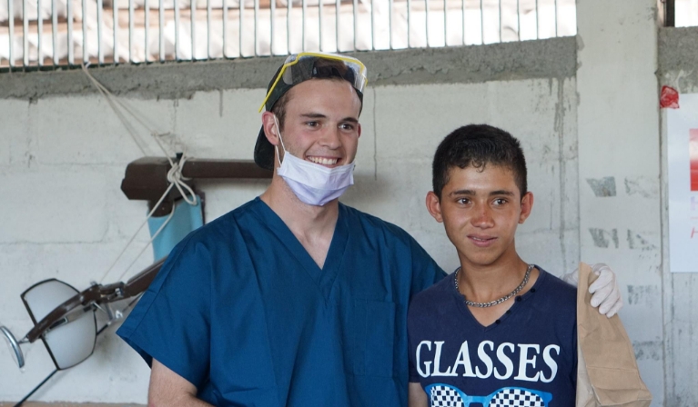 Doctor Clark Julian smiling with teenage boy