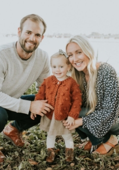 Doctor Julian smiling with his wife and child