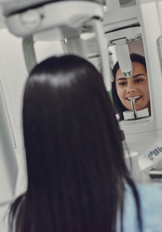 Woman getting a dental scan of her mouth and jaw