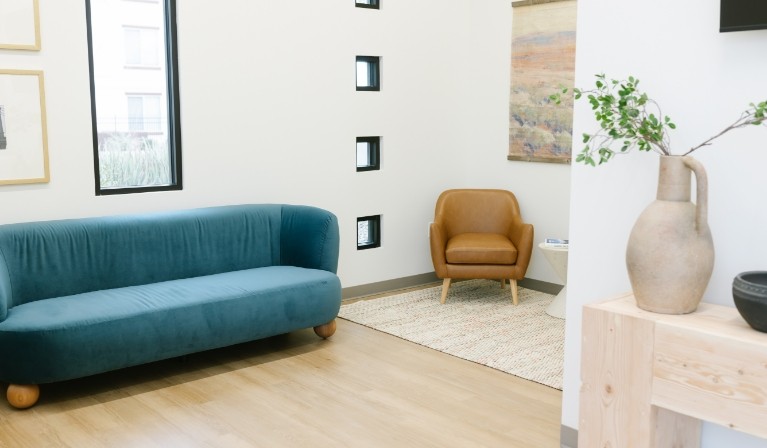 Blue couch and brown leather chair in reception area