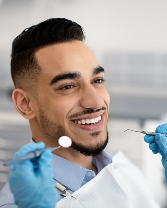 Young man smiling during preventive dentistry checkup